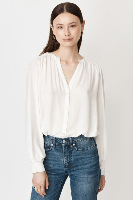 Notch neck long sleeved blouse in white with gathering at the shoulders