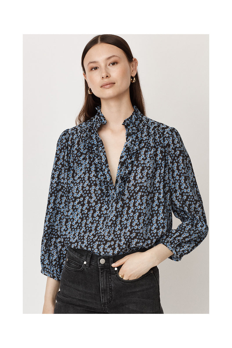 Ruffle collar three quarter length sleeves half placket with double ruffle blouse with black background and small blue and white star print