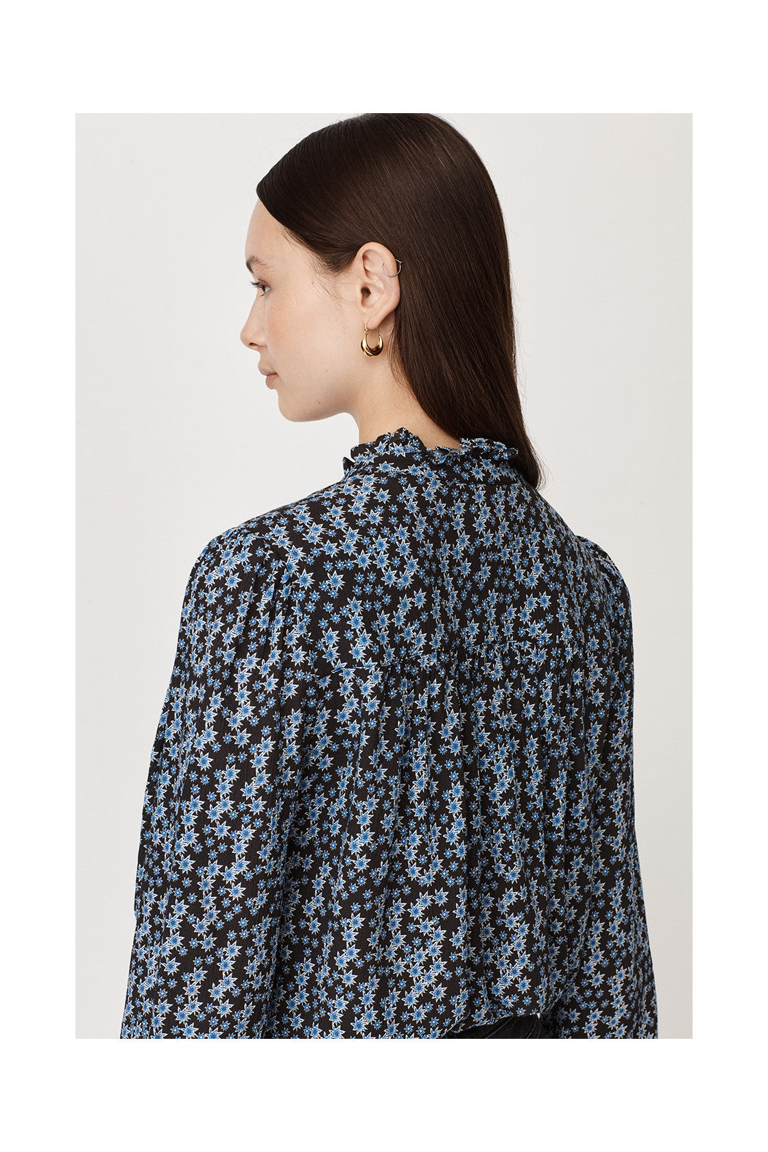 Ruffle collar three quarter length sleeves half placket with double ruffle blouse with black background and small blue and white star print