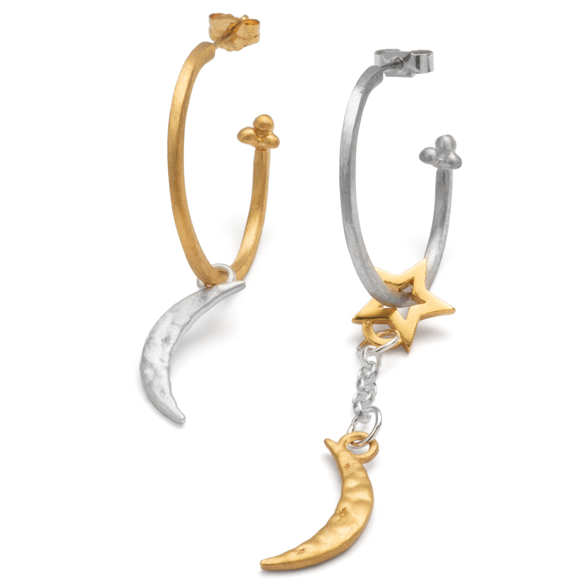 Mismatched hoop earrings with moon and star charms