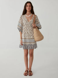 Short V neck summer dress with elbow length puff sleeves in an ecru with blue and brown floral pattern